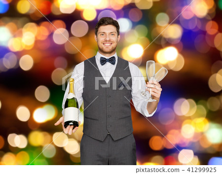 man with bottle of champagne and glasses at party 41299925