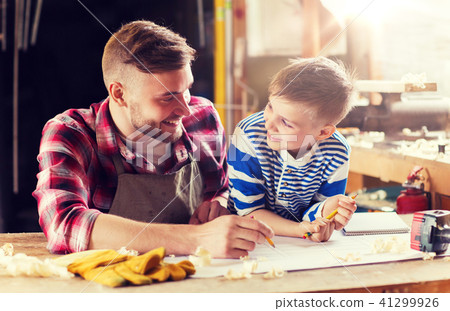 happy father and son with blueprint at workshop happy father and son with blueprint at workshop 41299926