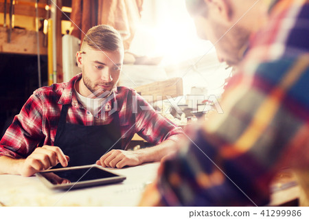 workmen with tablet pc and blueprint at workshop workmen with tablet pc and blueprint at workshop 41299986