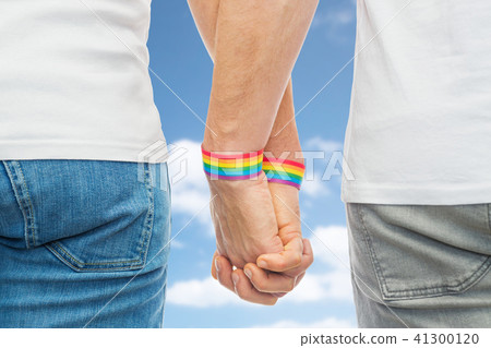 male couple with gay pride rainbow wristbands 41300120