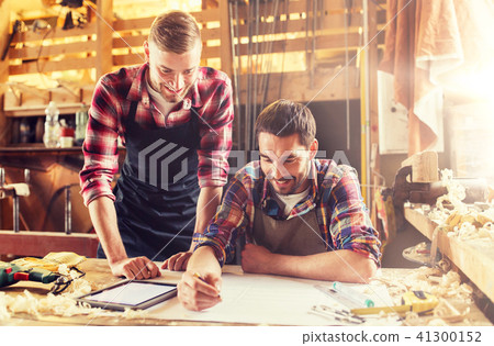workmen with tablet pc and blueprint at workshop workmen with tablet pc and blueprint at workshop 41300152