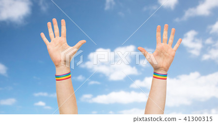 hands with gay pride rainbow wristbands 41300315