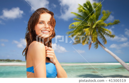 happy woman in bikini swimsuit on tropical beach 41300319