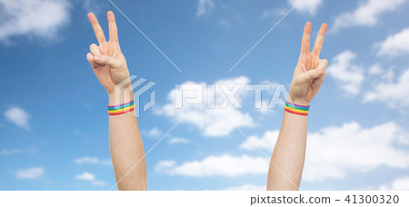 hands with gay pride rainbow wristbands make peace 41300320