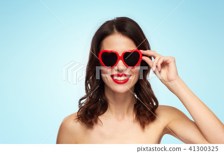 woman with red lipstick and heart shaped shades 41300325