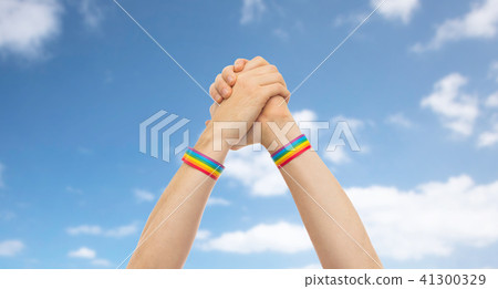 hands with gay pride wristbands in winning gesture 41300329