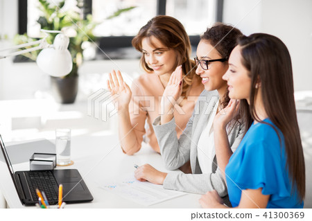 businesswomen having video chat at office 41300369