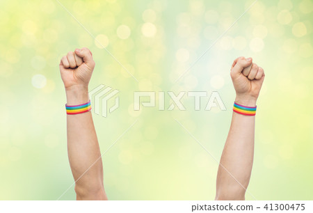 hands with gay pride rainbow wristbands shows fist 41300475