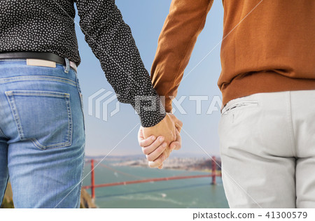 close up of male gay couple holding hands 41300579