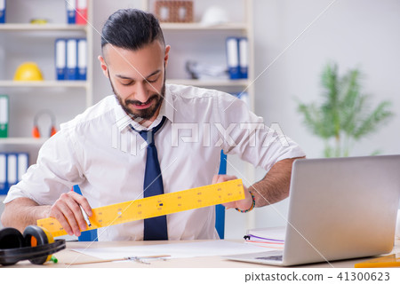 Architect working in his studio on new project Architect working in his studio on new project 41300623