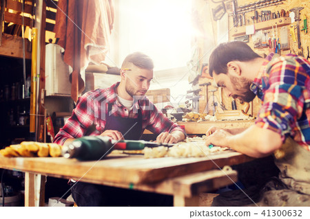carpenters with ruler and blueprint at workshop carpenters with ruler and blueprint at workshop 41300632