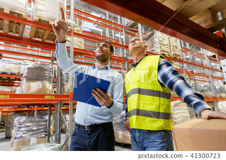 worker and businessman with clipboard at warehouse 41300723