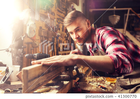 carpenter working with wood plank at workshop carpenter working with wood plank at workshop 41300770