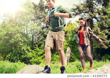 happy couple with backpacks hiking outdoors happy couple with backpacks hiking outdoors 41300771