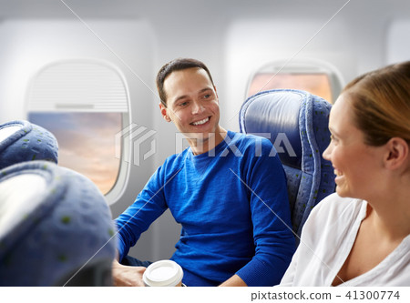 happy passengers with coffee talking in plane happy passengers with coffee talking in plane 41300774