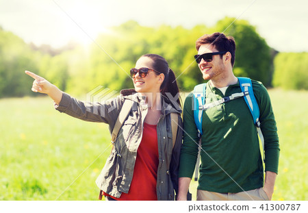happy couple with backpacks hiking outdoors happy couple with backpacks hiking outdoors 41300787