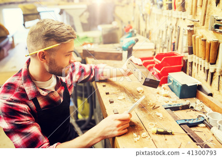 carpenter working with wood plank at workshop carpenter working with wood plank at workshop 41300793