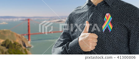 man with gay pride rainbow awareness ribbon 41300806