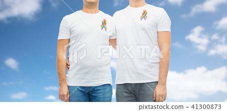 close up of couple with gay pride rainbow ribbons 41300873