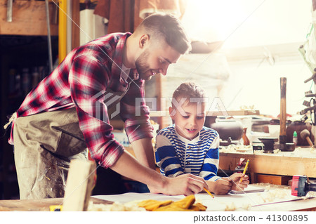 happy father and son with blueprint at workshop happy father and son with blueprint at workshop 41300895