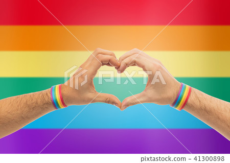 male hands with gay pride wristbands showing heart 41300898