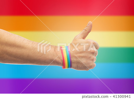 hand with gay pride rainbow wristband shows thumb hand with gay pride rainbow wristband shows thumb 41300941