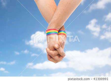hands of couple with gay pride rainbow wristbands hands of couple with gay pride rainbow wristbands 41300991