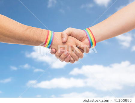 hands with gay pride wristbands make handshake 41300993