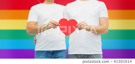 couple with gay pride rainbow wristbands and heart 41301014