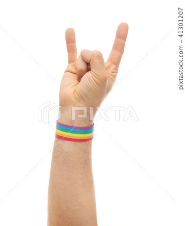 hand with gay pride rainbow wristband shows rock hand with gay pride rainbow wristband shows rock 41301207