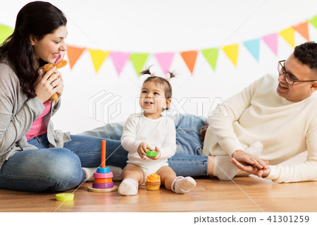 baby girl with parents playing with toys 41301259