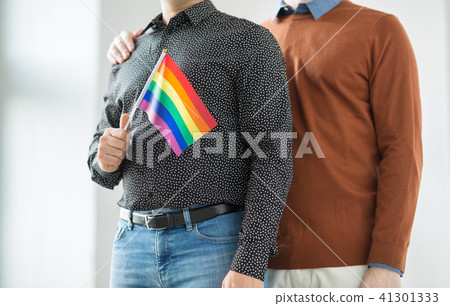 close up of happy male couple with gay pride flags 41301333