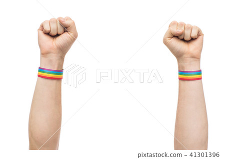 hands with gay pride rainbow wristbands shows fist 41301396