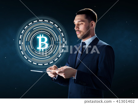 businessman with tablet pc and bitcoin hologram 41301402