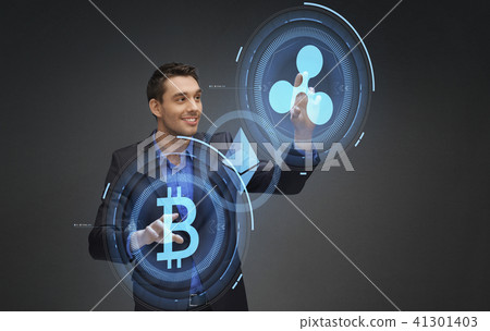 businessman with cryptocurrency holograms businessman with cryptocurrency holograms 41301403