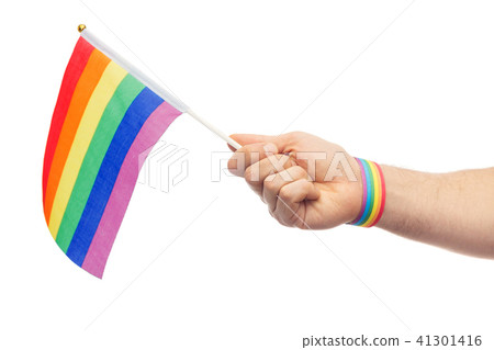 hand with gay pride rainbow flag and wristband 41301416