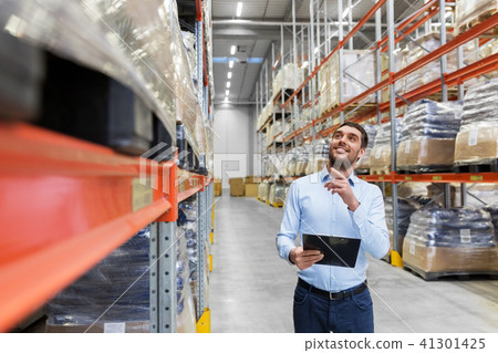 happy businessman with clipboard at warehouse 41301425