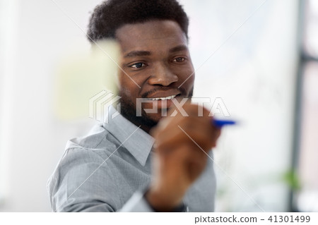 businessman writing on glass board at office 41301499