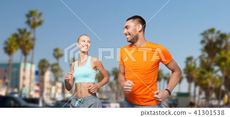 smiling couple jogging at summer over venice beach smiling couple jogging at summer over venice beach 41301538