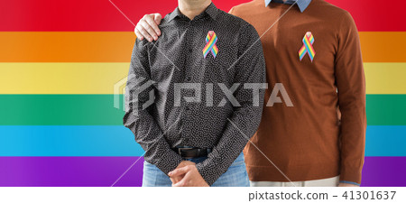 close up of couple with gay pride rainbow ribbons 41301637