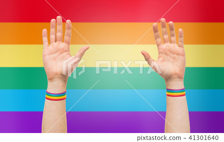 hands with gay pride rainbow wristbands 41301640