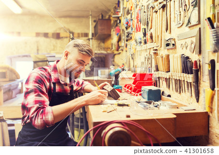 carpenter working with wood plank at workshop carpenter working with wood plank at workshop 41301658