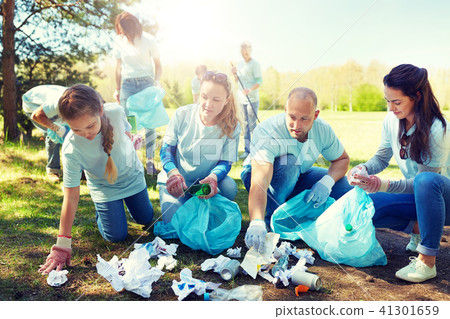 volunteers with garbage bags cleaning park area volunteers with garbage bags cleaning park area 41301659