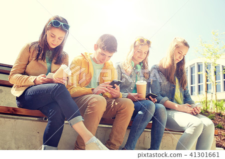 teenage friends with smartphone and coffee cups teenage friends with smartphone and coffee cups 41301661