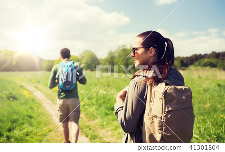 happy couple with backpacks hiking outdoors happy couple with backpacks hiking outdoors 41301804