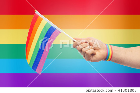 hand with gay pride rainbow flag and wristband 41301805
