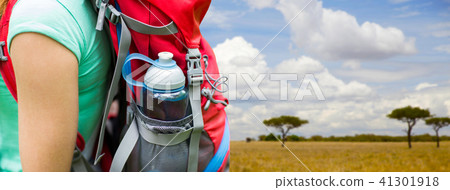 close up of woman with water bottle in backpack 41301918