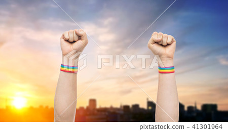 hands with gay pride rainbow wristbands shows fist 41301964