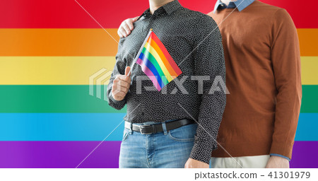 close up of male couple with gay pride flag 41301979