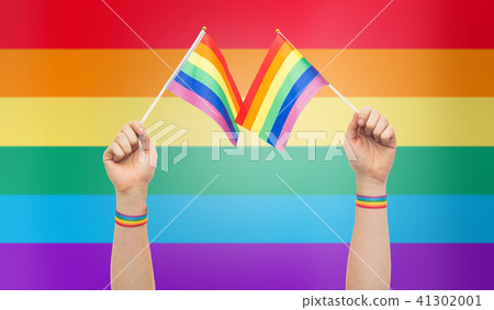 hand with gay pride rainbow flags and wristbands 41302001